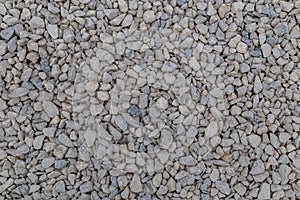 Dry white limestone ballast flat full frame background. Small gray dusty broken macadam stones texture.