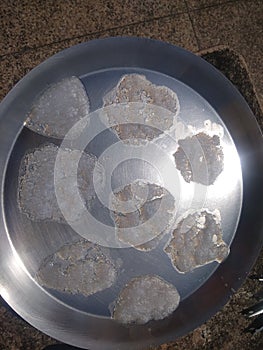 Dry white sabu on plate on floor