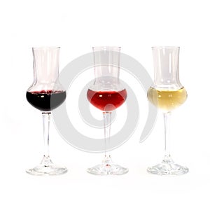 Dry white, semi-sweet rose and vintage aged tannin red wine in small tasting glasses isolated on white background. For winery, bar