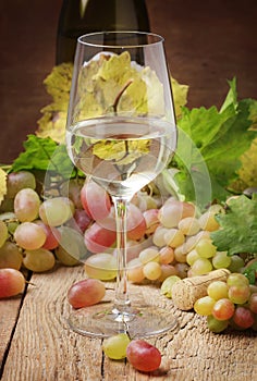 Dry white wine in glass, still life in rustic style, vintage woo