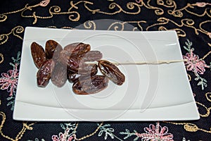 Dryed Dates. Dates on a white plate.