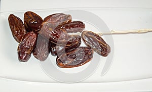 Dryed Dates. Dates on a white plate.