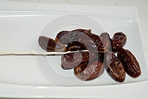 Dryed Dates on a white plate.