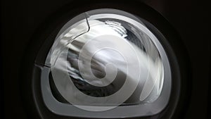 Dryer machine drying rotating swirl spin closeup porthole 4k