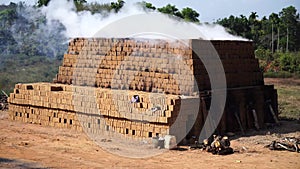 Drying and burning of bricks made of clay with fire wood