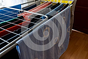 Drying colorful variety of clothes on a clothes-horse