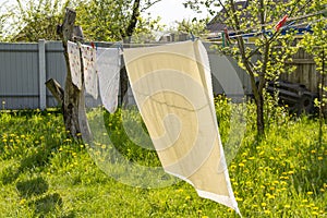 drying of fresh clean laundry on the washing line outdoors. Purity and freshness