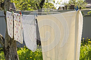 drying of fresh clean laundry on the washing line outdoors. Purity and freshness