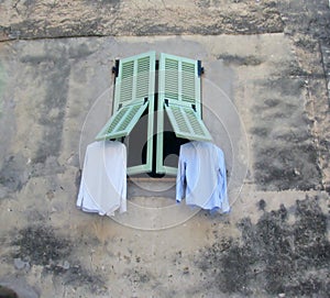 Drying freshly washed laundry outside the window.