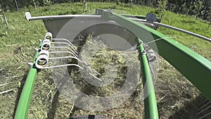 Drying hay by turning with a rotor tractor rake