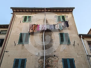 Drying laundry at the facade of an oldresidential house in the Tuscany