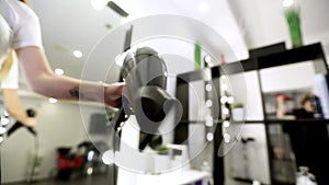 Drying long blonde hair with hair dryer and round brush.