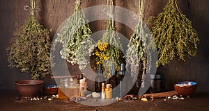 Drying medical herbs, honey, spices and bottle with essential oil for use in alternative medicine