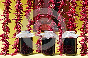 Drying paprikas and jars of cherry brandy in front of a house, Slavonia, Croatia