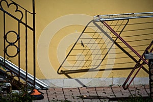 Drying rack and its shadow casted on a wall