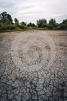 Dry lake in Bavaria Germany. Drought and climate change, landscape of cracked earth after lake has dried up in summer. Water