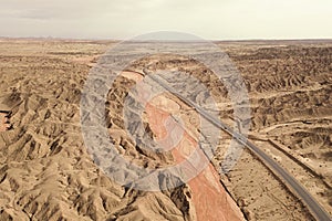 Dryness land with erosion terrain with highway crossing