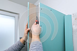 Drywall bulkhead construction in domestic bathroom. cutting gypsum sheet