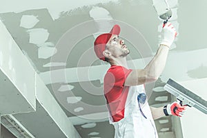 Drywall Ceiling Patching by Remodeling Worker