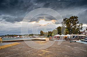 View of tthe harbor and beach in Megalo Pefko Nea Peramos under a dramatic sky at sunset,Attica,Greece photo