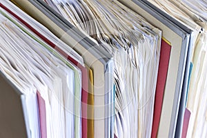 Closeup of document binders with papers and tabs