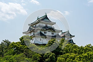 Wakayama Castle Tenshukaku, one of Japan's top 100 castles, against a clear blue sky. Japan