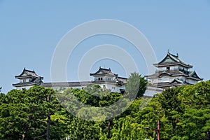 Wakayama Castle Tenshukaku, one of Japan's top 100 castles, against a clear blue sky. Japan