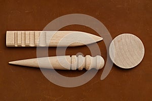 Multi-Size Burnisher, Leather Craft Round Wood Edge Slicker for Leather Craft on Genuine Leather Background photo