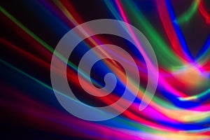 Multicoloured lines of light against a dark background