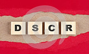 DSCR word on wooden cubes on red torn paper , financial concept background