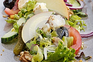 Fresh salad with grilled goat cheese wit fruit and vegetables