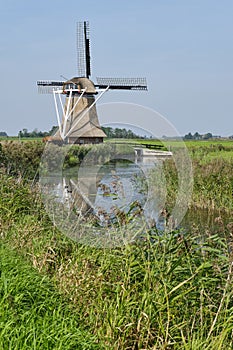 View on a traditional thatched dutch windmill in Hantum