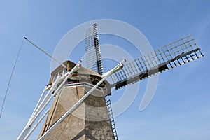 Closeup of the four wings of a traditional dutch windmill in Hantum