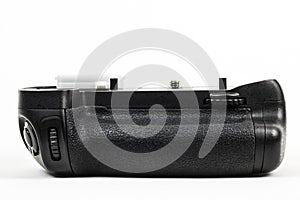 DSLR camera battery grip color black isolated in white. Front view.