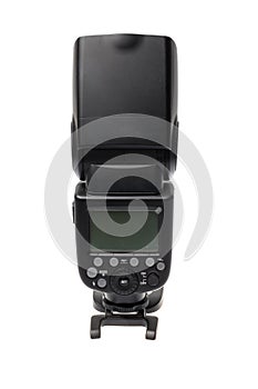 DSLR camera speedlite flash with its display on its stand, isolated on white background