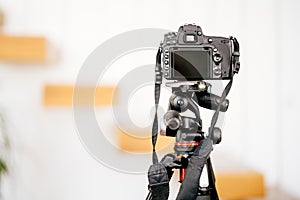 dslr camera standing on tripod and taking interior design photos