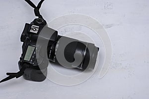 A dSLR camera on a white background. Selective focus