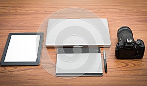 DSLR digital camera with tablet and notebook laptop