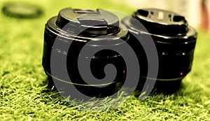 Dslr prime lens on grassy background .Selective focus blurry background photo