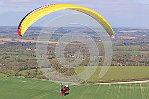 Tandem Paraglider flying at Combe Gibbet, England photo