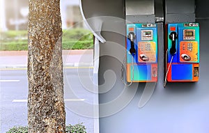 The dual unused pay phones on the footpath