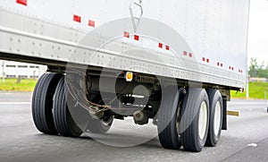 Dual wheels trailer axles on the running on the road dry van semi trailer with cargo