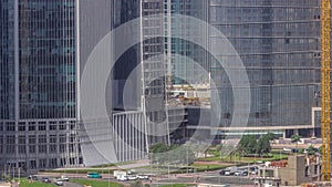 Dubai business bay district with office skyscrapers and traffic on the road intersection aerial timelapse.