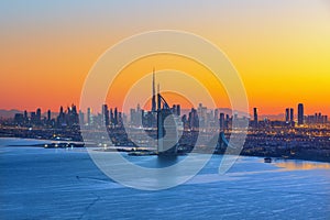 Dubai city skyline and Jumeirah beach  at sunrise, United Arab Emirates