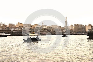 Dubai Creek with abra boats. Local people and tourists using water taxi and ferry in old town river. Traditional cruise.