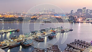 Dubai creek landscape day to night with boats and ship near waterfront