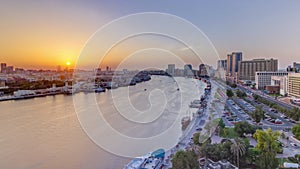 Dubai creek landscape at sunset timelapse with boats and ship near waterfront