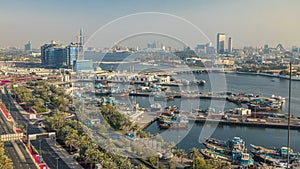 Dubai creek landscape timelapse with boats and ship in port and modern buildings in the background during sunset