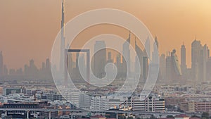 Dubai creek landscape timelapse with waterfront and modern buildings in the background during sunset