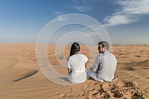 Dubai dessert sand dunes, couple on Dubai desert safari,United Arab Emirates, couple men and woman on city trip Dubai